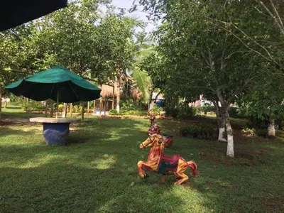 a statue of a woman riding a horse in the grass at Casafinca en Arjona # 3 in Cartagena de Indias