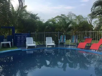 a group of chairs sitting around a swimming pool at Casafinca en Arjona # 3 in Cartagena de Indias