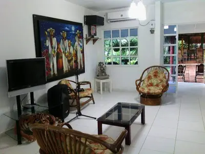 a living room with a flat screen tv and chairs at Casafinca en Arjona # 3 in Cartagena de Indias
