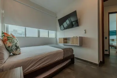 a bedroom with a bed with a tv on the wall at Espectacular vista al mar - Infinito 2502 in Cartagena de Indias