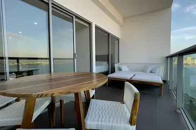 a dining room with a table and chairs and windows at Infinitum Spectacular 23rd floor 1 BR Condo in Cartagena de Indias