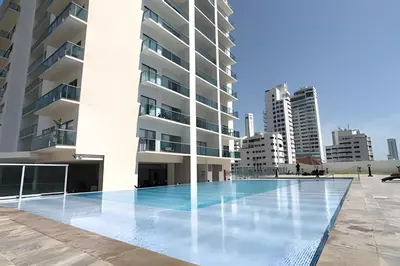 a swimming pool in front of a building at Infinitum Spectacular 23rd floor 1 BR Condo in Cartagena de Indias