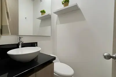 a bathroom with a white sink and a toilet at Infinitum Spectacular 23rd floor 1 BR Condo in Cartagena de Indias