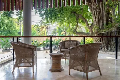 a group of chairs and a vase on a porch at Modern apt near the beach with Jacuzzi, Cartagena in Cartagena de Indias