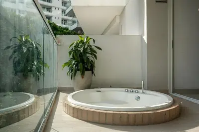 a bath tub in a room with a plant at Modern apt near the beach with Jacuzzi, Cartagena in Cartagena de Indias