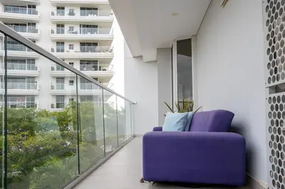 a purple chair on a balcony with a building at Modern apt near the beach with Jacuzzi, Cartagena in Cartagena de Indias