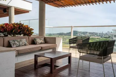 a patio with a couch and chairs and a table at Modern apt near the beach with Jacuzzi, Cartagena in Cartagena de Indias