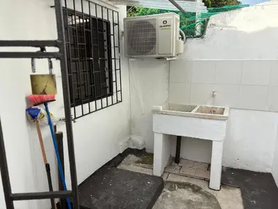 a small room with a sink and a microwave at Comfortable and quiet apartment in Cartagena de Indias