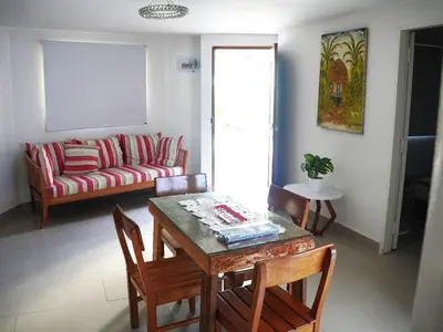 a living room with a table and chairs and a couch at Comfortable and quiet apartment in Cartagena de Indias