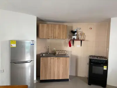 a kitchen with a stainless steel refrigerator and a stove at Comfortable and quiet apartment in Cartagena de Indias