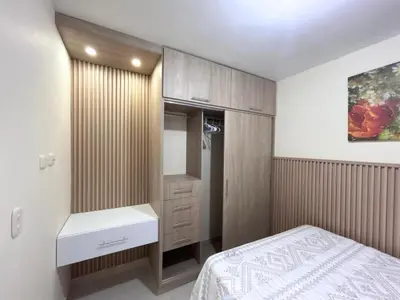 a bedroom with a bed and a dresser and a mirror at Team Renacer Broker Brisas del Mar and Pool in Cartagena de Indias