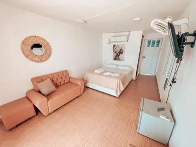 a living room with a bed and a couch at Margarita's Beach Club in Playa Punta Arena
