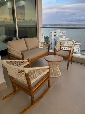 a living room with a couch and chairs on a balcony at Apartamento en Palmetto sunset frente al mar piso 20 in Cartagena de Indias