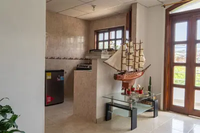 a kitchen with a glass table with a model ship on it at Donde Mire in Puerto Colombia