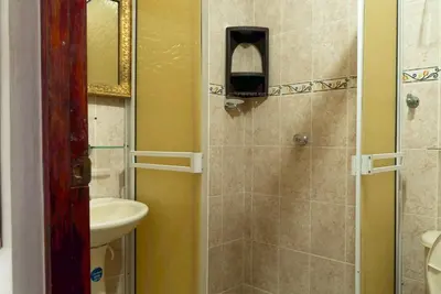 a bathroom with a shower with a sink and a toilet at Donde Mire in Puerto Colombia