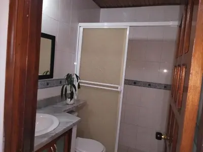 a bathroom with a toilet and a sink and a mirror at Apartamento en Manga cerca al Centro Historico in Cartagena de Indias