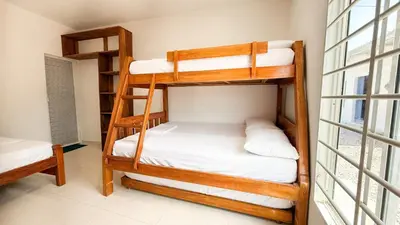 a bunk bed room with two bunk beds and a window at Cabaña Datalu 2 in Coveñas