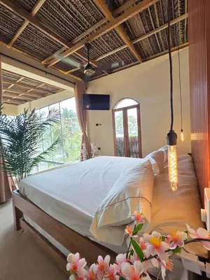 a bedroom with a large bed in a room at Lotus Beach House playa privada in San Silvestre