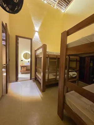 a room with two bunk beds and a mirror at Lotus Beach House playa privada in San Silvestre