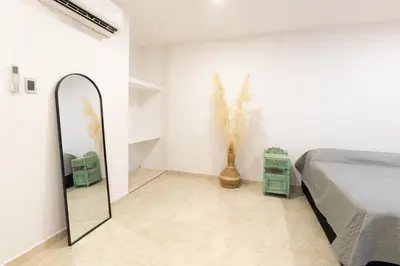 a bedroom with a mirror and a bed in a room at Oasis Colonial Cartagena in Cartagena de Indias
