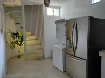a kitchen with a refrigerator and a staircase at Oasis Colonial Cartagena in Cartagena de Indias