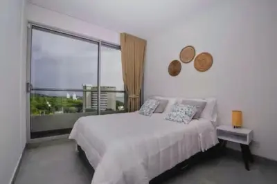 a bedroom with a bed and a large window at Santa Marta apartamento con vista al mar- santamarina-709 in Santa Marta