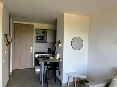 a kitchen and living room with a table in a room at Santa Marta apartamento con vista al mar- santamarina-709 in Santa Marta