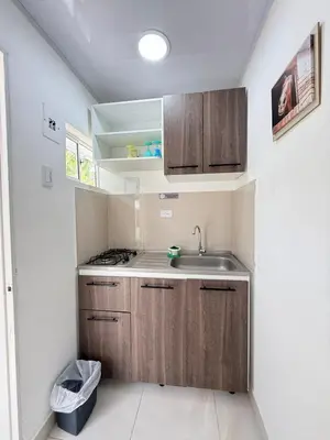 a kitchen with wooden cabinets and a sink at Calidad vs precio, wifi, cerca centro historico 3-2 in Cartagena de Indias