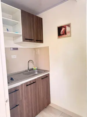a kitchen with wooden cabinets and a sink at Calidad vs precio, wifi, cerca centro historico 3-2 in Cartagena de Indias