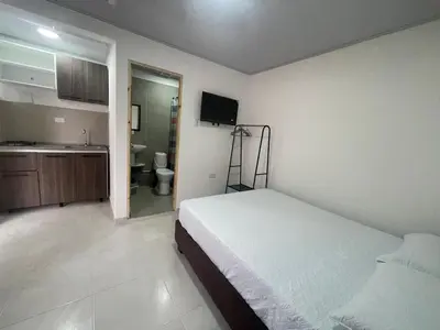 a bedroom with a bed and a bathroom with a sink at Calidad vs precio, wifi, cerca centro historico 3-2 in Cartagena de Indias