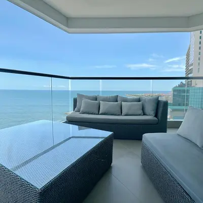 a living room with a couch and a view of the ocean at by Calamari Homes - Murano Elite 1901 Bocagrande in Cartagena de Indias