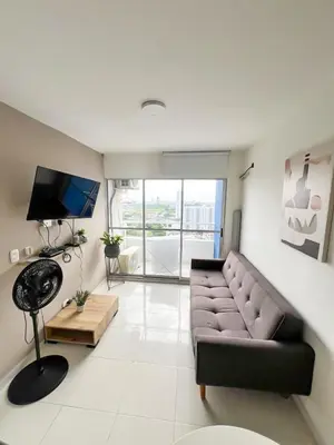 a living room with a couch and a television at Moderno apto a pasos de la playa in Cartagena de Indias