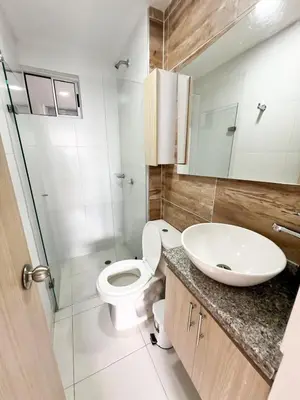 a bathroom with a white toilet and a sink at Moderno apto a pasos de la playa in Cartagena de Indias