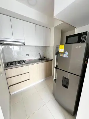 a kitchen with a stainless steel refrigerator and white cabinets at Moderno apto a pasos de la playa in Cartagena de Indias