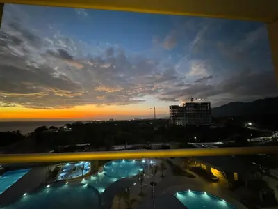a view of a sunset from the balcony of a building at Apartamento cerca al mar santa Marta- santamarina-614 in Santa Marta