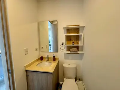 a bathroom with a toilet and a sink and a mirror at Apartamento cerca al mar santa Marta- santamarina-614 in Santa Marta
