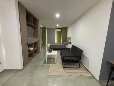 a room with a bed and a chair and a table at Coral Tower in Barranquilla