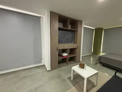 a living room with a bed and a table at Coral Tower in Barranquilla