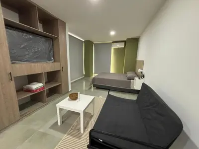 a room with a bed and a couch and a table at Coral Tower in Barranquilla