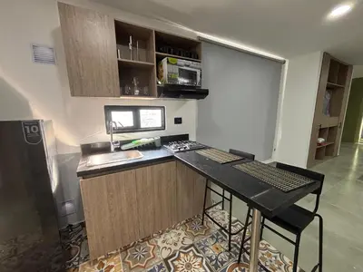 a kitchen with a counter with a sink and a stove at Coral Tower in Barranquilla