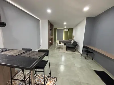 a living room with a table and chairs and a couch at Coral Tower in Barranquilla