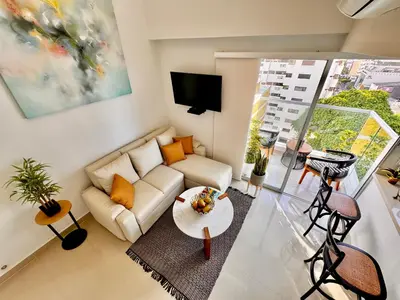 a living room with a couch and a table at Stunning Bocagrande Beach Apartment in Cartagena de Indias