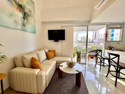 a living room with a couch and a table at Stunning Bocagrande Beach Apartment in Cartagena de Indias