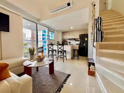 a living room with a couch and a table at Stunning Bocagrande Beach Apartment in Cartagena de Indias