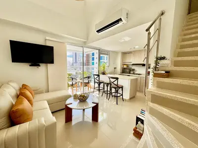 a living room with a couch and a table at Stunning Bocagrande Beach Apartment in Cartagena de Indias