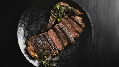 a plate of food with meat and greens on it at Four Seasons Hotel & Residences Cartagena in Cartagena de Indias