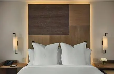 a bedroom with a large bed with white pillows at Four Seasons Hotel & Residences Cartagena in Cartagena de Indias