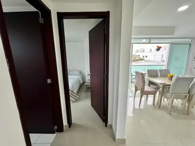 a dining room with a table and a table and chairs at Dubai 202 in Barranquilla