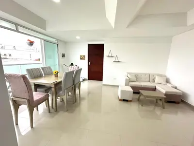 a living room with a couch and a table and chairs at Dubai 202 in Barranquilla