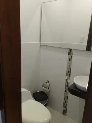 a small bathroom with a toilet and a sink at Bijao 4a in Barranquilla